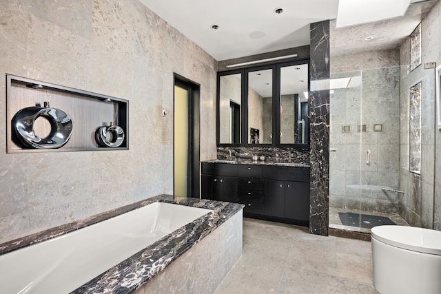 full bathroom featuring tile walls, toilet, vanity, and plus walk in shower