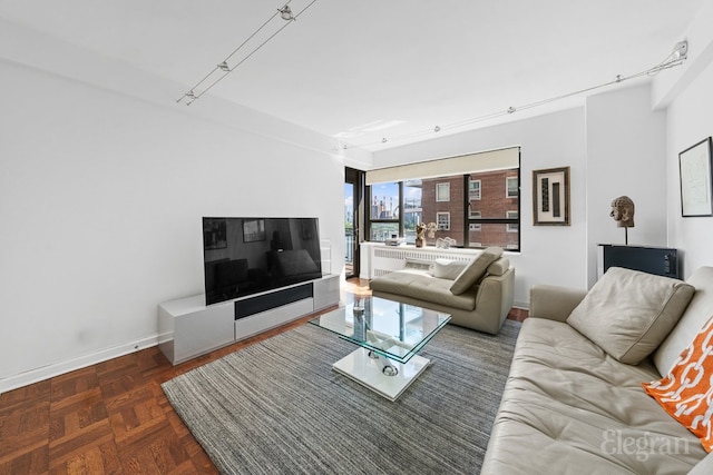 living room with baseboards and track lighting