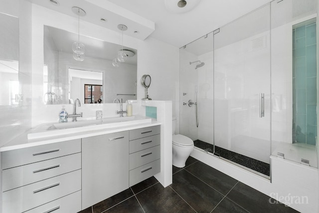 bathroom with visible vents, toilet, a shower stall, vanity, and tile patterned flooring