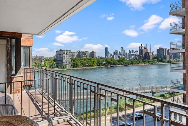 balcony featuring a view of city and a water view