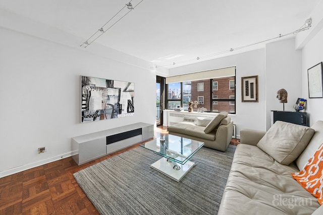 living room with track lighting and baseboards