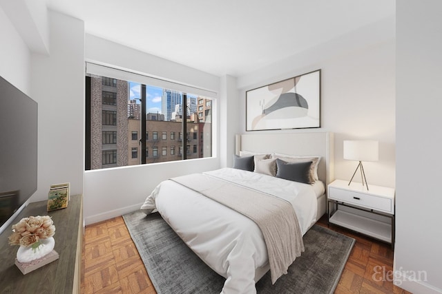 bedroom featuring a view of city and baseboards