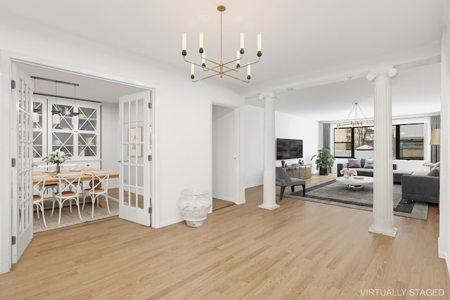 40 E 84th St Unit 4A, New York City, NY 10028 - living area featuring ornate columns, wood finished floors, a chandelier, and baseboards