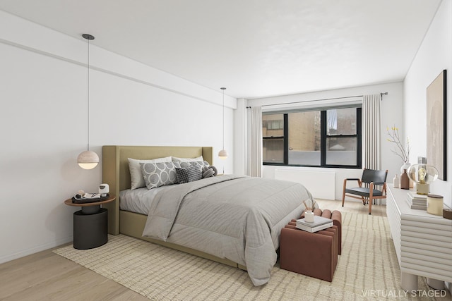 bedroom with baseboards and wood finished floors