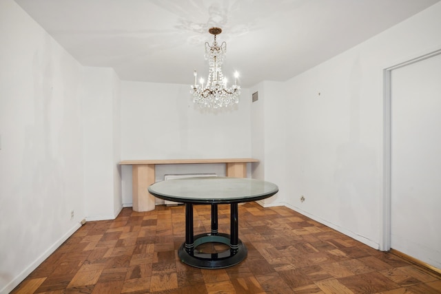 dining area with baseboards and an inviting chandelier