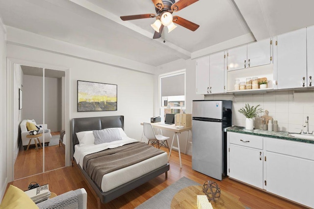 325 W 45th St Unit 403-A, New York City, NY 10036 - bedroom with freestanding refrigerator, a sink, and light wood-style flooring