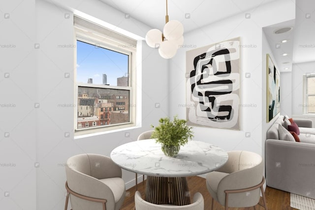 dining area featuring a view of city, recessed lighting, wood finished floors, and a healthy amount of sunlight