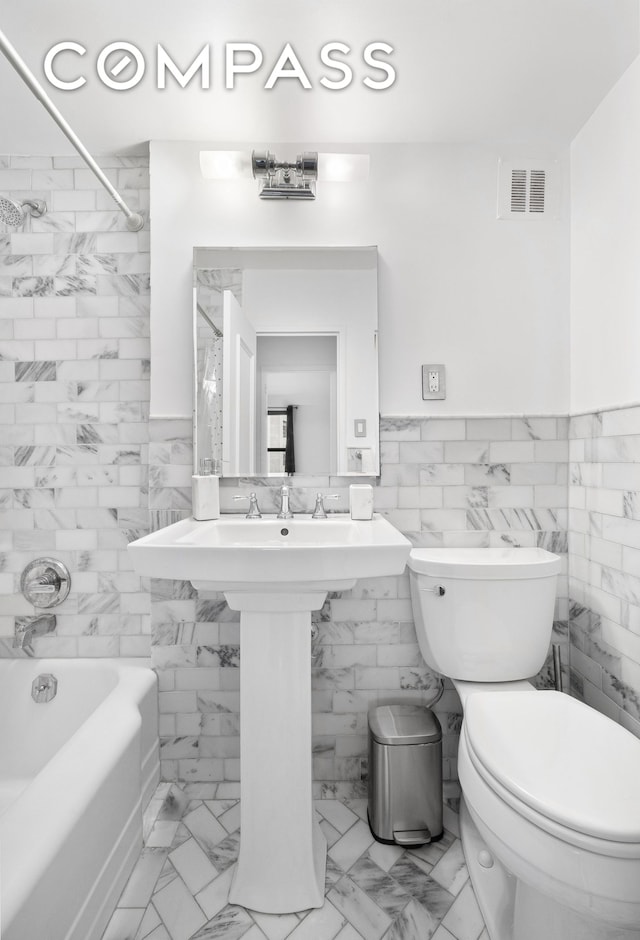 bathroom featuring tub / shower combination, visible vents, toilet, and marble finish floor