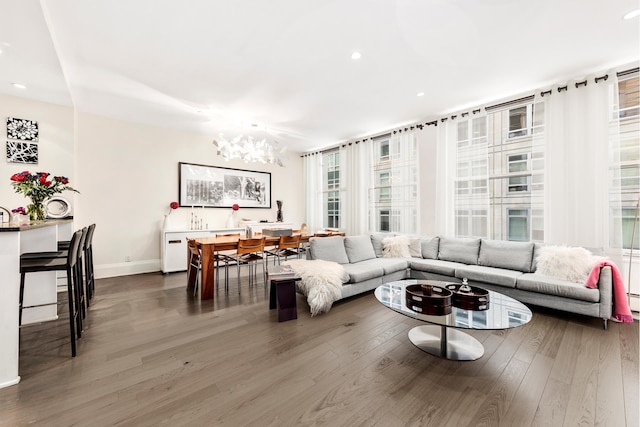 living area featuring baseboards, wood finished floors, and recessed lighting