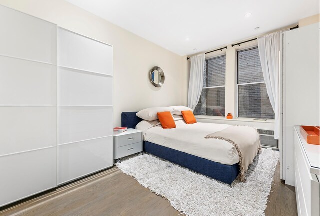 bedroom featuring dark hardwood / wood-style flooring