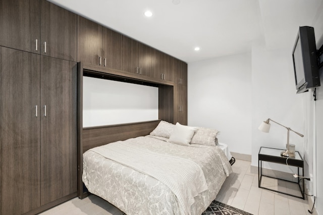 bedroom featuring baseboards, light wood finished floors, and recessed lighting