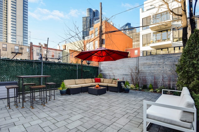 view of patio featuring fence and an outdoor hangout area