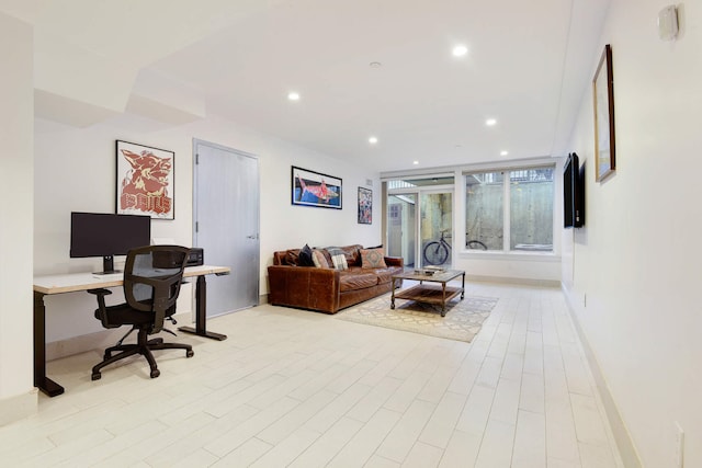 interior space featuring baseboards, light wood-style flooring, and recessed lighting