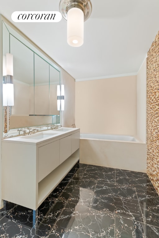 bathroom featuring a tub, crown molding, backsplash, and vanity