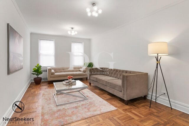 living room with ornamental molding and parquet flooring