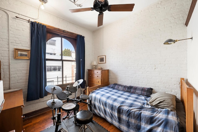 210 Spring St Unit 5Fl, New York City, NY 10013 - bedroom featuring wood finished floors, brick wall, and ceiling fan