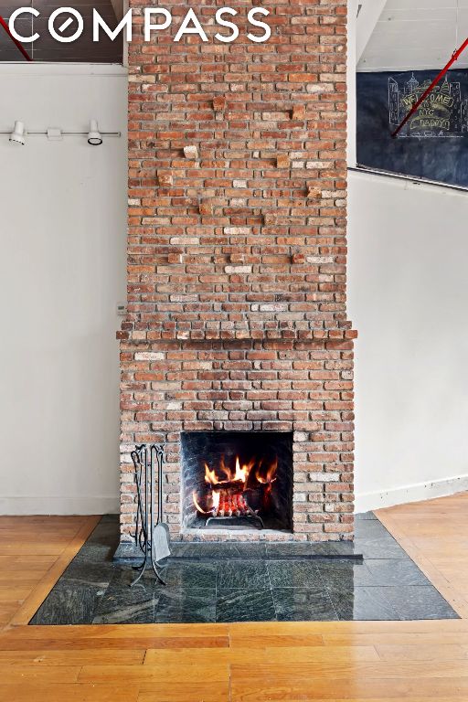 room details featuring hardwood / wood-style floors and a fireplace