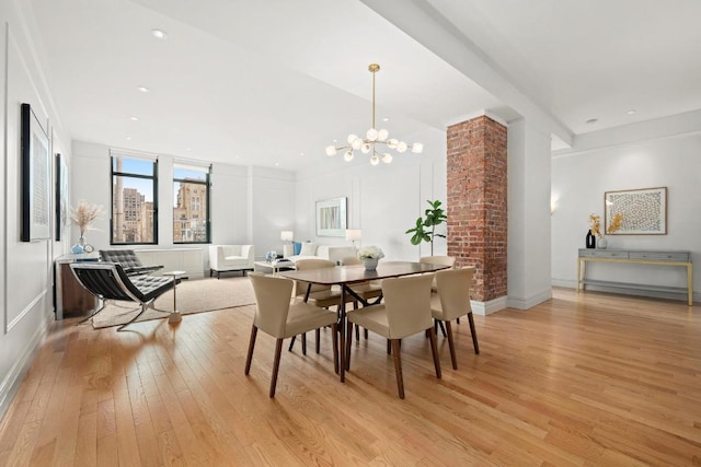 dining room featuring an inviting chandelier and light wood-type flooring