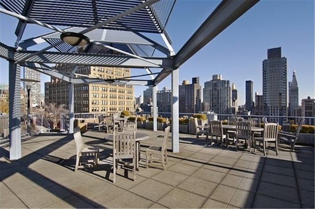 view of patio / terrace with a view of city and a pergola