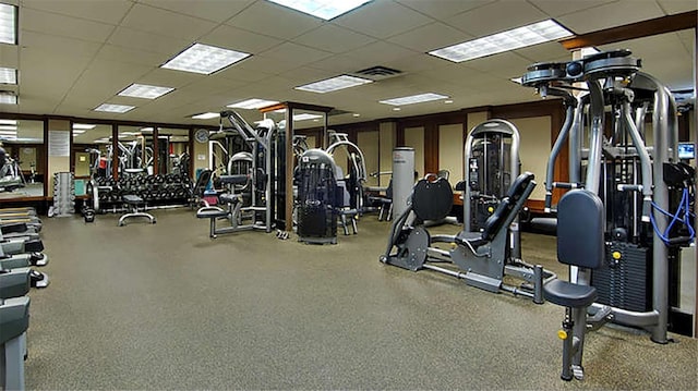 exercise room with visible vents and a paneled ceiling