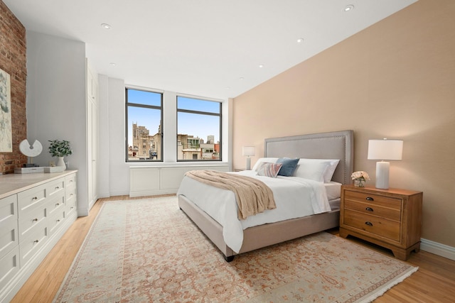 bedroom featuring light wood-style floors and baseboards