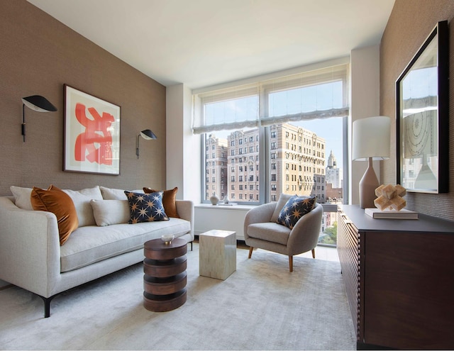 living area with a view of city and light carpet