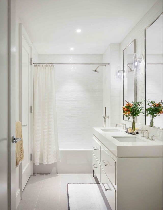 212 W 72nd St Unit 4H, New York City, NY 10023 - bathroom with shower / bath combo with shower curtain, tile patterned floors, and double vanity