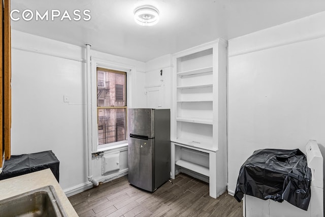 kitchen with baseboards, dark wood-style floors, and freestanding refrigerator