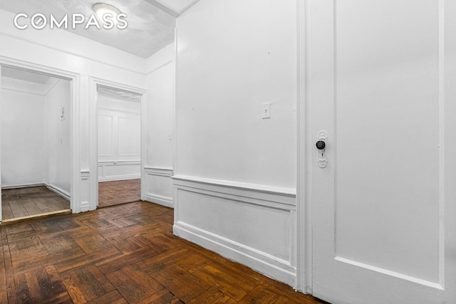 interior space featuring wainscoting and a decorative wall