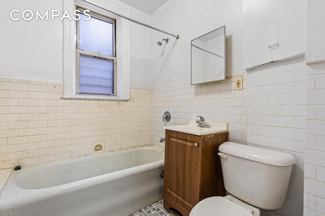 full bath with toilet, vanity, a tub to relax in, tile patterned floors, and tile walls