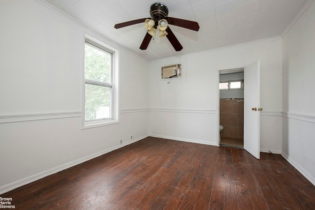 unfurnished room with dark wood-type flooring, a wall mounted air conditioner, crown molding, and baseboards