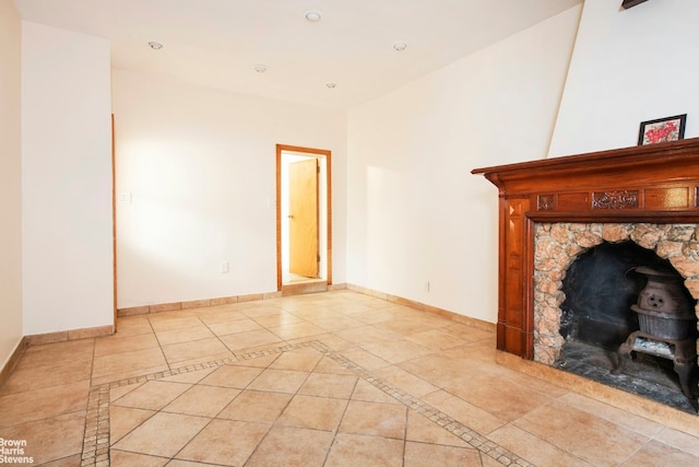 unfurnished living room with light tile patterned floors, recessed lighting, and baseboards