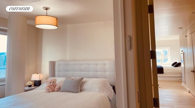 bedroom with light wood-type flooring and visible vents