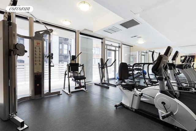 exercise room with expansive windows and visible vents