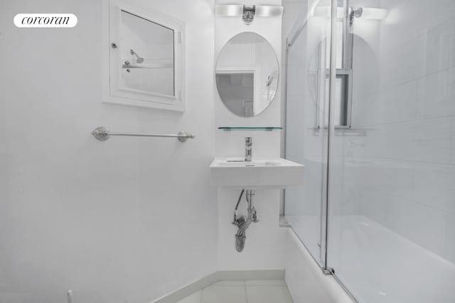 bathroom featuring tile patterned floors and enclosed tub / shower combo