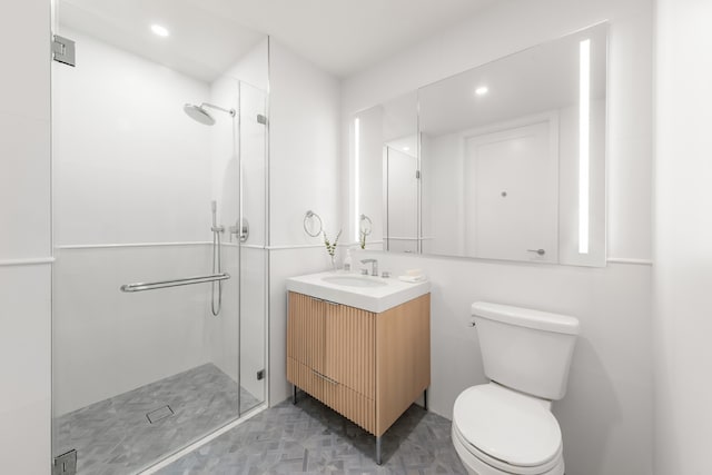 bathroom featuring toilet, vanity, and walk in shower