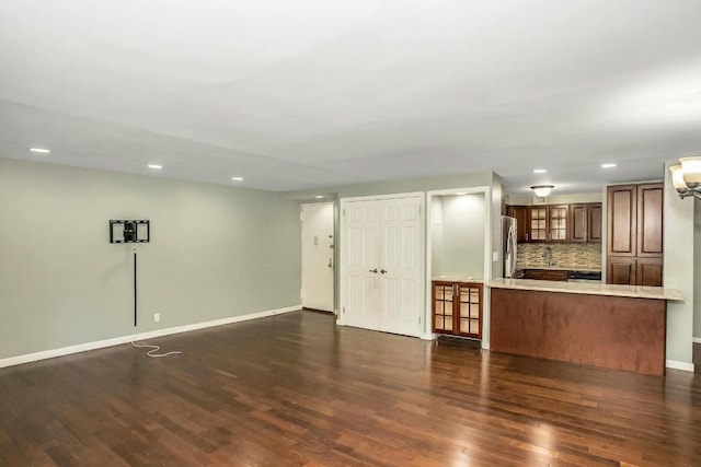 unfurnished living room featuring dark hardwood / wood-style flooring