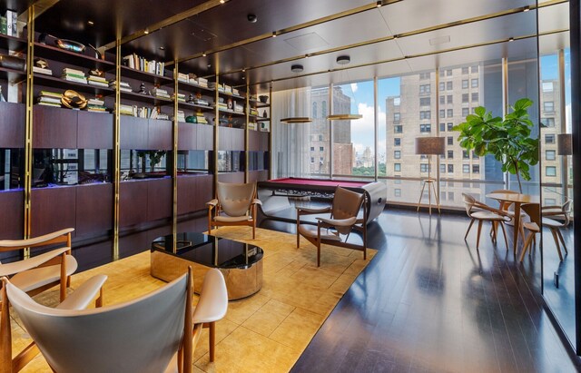 bedroom featuring hardwood / wood-style flooring and expansive windows