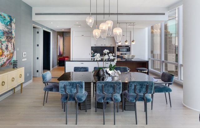 dining area with light wood-type flooring and recessed lighting