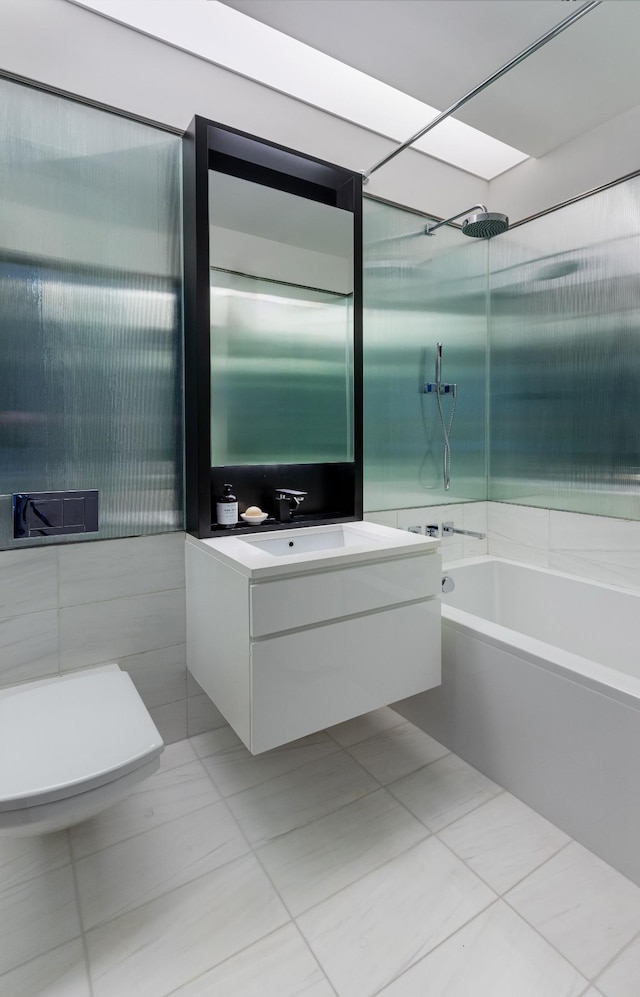 full bathroom with shower / bathtub combination, toilet, tile walls, vanity, and tile patterned floors