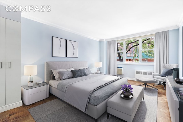 bedroom featuring baseboards, ornamental molding, wood finished floors, and radiator