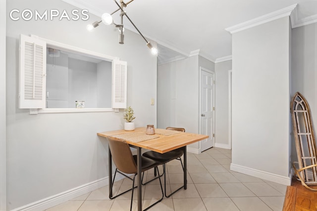 dining room with ornamental molding, baseboards, and light tile patterned floors