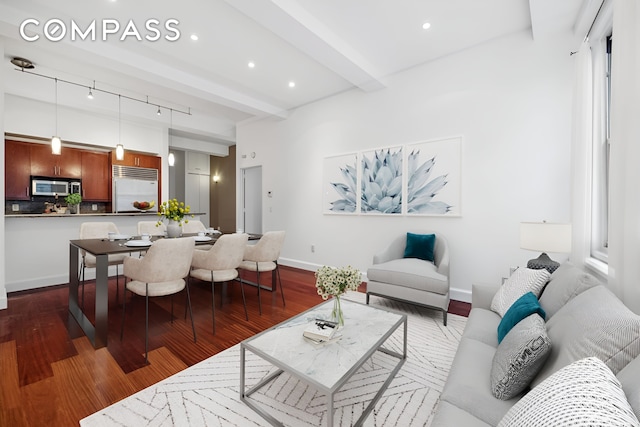 living area with recessed lighting, beamed ceiling, baseboards, and wood finished floors