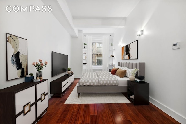 bedroom with dark wood-type flooring