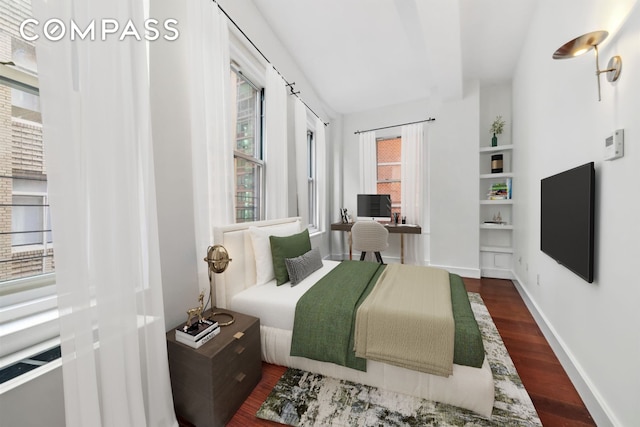 bedroom with dark wood-style floors and baseboards