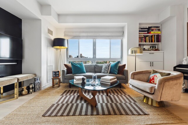 interior space featuring built in shelves and light hardwood / wood-style floors