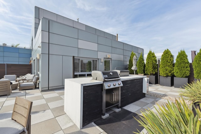 view of patio with a grill, an outdoor kitchen, and an outdoor living space