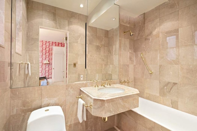 bathroom with sink, tile walls, and a tile shower