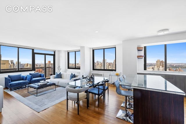 living room with a view of city and wood finished floors