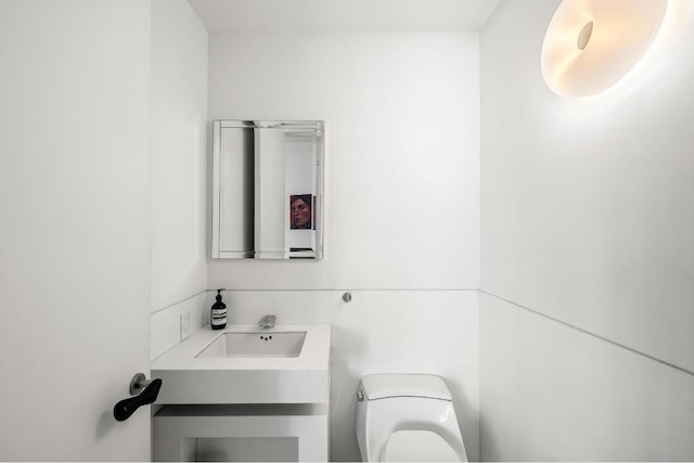 bathroom featuring toilet and vanity